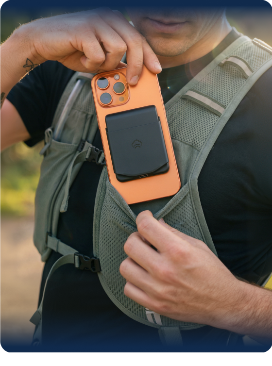 earbud case attached to phone being used outdoors